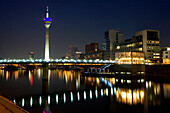 Modern architecture of the Media Harbour at night with television tower, Neuer Zollhof, Düsseldorf, state capital of NRW, North-Rhine-Westphalia, Germany