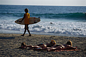Beach scene, two women sunbathing, boy with surfboard, Playa Zicatela, Puerto Escondido, Oaxaca, Mexico, America