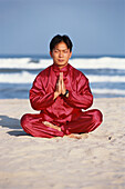 Mann macht Yoga am Strand, Yogaübungen, China Beach und Meer, Harmonie, Ausgeglichenheit, Energie, Meditation, Danang, Vietnam
