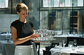 A waitress carrying glasses  in Restaurant Lasalle, Zurich, Switzerland
