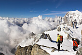 Two mountaineers climbing mount Dent du Geant, Mont Blanc in background, France, Italy