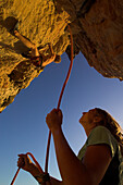 Free climber scaling rock face, Nosy Andantsara, Madagascar