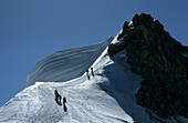mountaineerers at corniced ridge of Mont Blanc du Tacul, Mont Blanc range, France