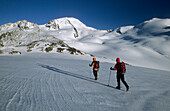 two mountaineerers on their way to glacier Hintereisferner beneath Weißkugel, Ötztal range, Tyrol, Austria