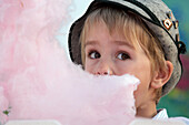 Boy (3-4 years) eating cotton candy