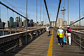 Pedestrians on Brooklyn Bridge with view of Manhattan Skyline, New York City, New York, USA