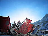 People resting in reclining chairs near Teufelsegg alpine hut, Schnalstal, South Tyrol, Italien