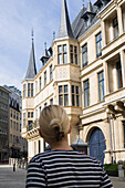Young woman in front of Grand Ducal Palace, Luxembourg