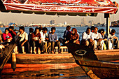 People sitting aloing the waterfront, Dubai Creek, United Arab Emirates, UAE