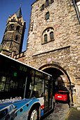 Bus passing St. Nicholas' Gate, Church of St. Nicholas in background, Eisenach, Thuringia, Germany