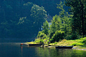 Wooden jetty and boat at Hohenwart lake, Linkenmuehle, Thuringia, Germany