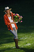 Young woman holding a bunch of tulips, Upper Bavaria, Bavaria, Germany