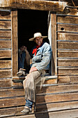 cowboy sitting in barn window, wildwest, Oregon, USA