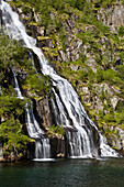 A waterfall on the island of Austvagoya, Fiord, Trollfjord, Austvagoya Island, Lofoten, Norway