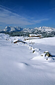 lodge Straubinger haus deeply snow-covered with view to wWilder Kaiser range and Unternberghorn, Eggenalm, Fellhorn, Chiemgau range, Chiemgau, Upper Bavaria, Bavaria, Germany