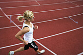 Woman runner on cinder track, , Carinthia, Austria