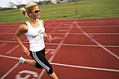 Woman runner on cinder track, Carinthia, Austria