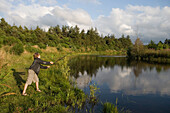 Boy Fishing at Lake, Near Henne, Central Jutland, Denmark