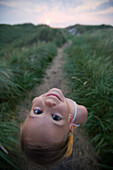 Girl in dunes looking back, Sylt island, Schleswig-Holstein, Germany