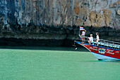 Ship, excursion boat in front of limestone cliffs, Ao Phang Nga, Thailand
