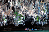 Fishing boat under limestone cliffs, Phang Nga Bay, Thailand