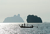 Fischermen in a small boat, south of Ko Lanta, Krabi, Thailand