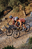 Two people mountainbiking, on a mountain bike tour, near Soller, Mallorca, Balearic Islands, Spain