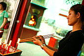 Woman with Joss Sticks and candles, Temple, Singapore
