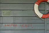Life belt and graffiti on a wooden wall, Lake Wessling, Wessling, Bavaria, Germany