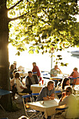 Guests sitting in a beer garden, Restaurant Woerl, Lake Woerthsee, Bavaria, Germany