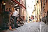 People eating out in a street restaurant, Gamla Stan Old Town, Stockholm, Sweden