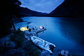 Man camping on small island, dusk, camp fire, lake, Valencia region, Spain