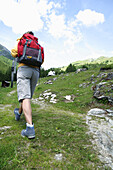 Female hiker on the way to a chapel, Heiligenblut, Hohe Tauern National Park, Carinthia, Austria