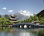 Deyue Pavilion (Moon-Embracing Pavilion) at the Hei Long Tan (black Dragon Pool) Park. Yulong (Jade Dragon Snow Mountain) in backgroud. Lijiang. Yunnan province, China