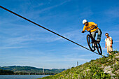 Trial biker on steel rope at Danube River, Linz