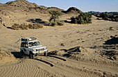 Tourists on four wheel drive wilderness safari, Kaokoland, Namibia