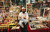 Salesman of amber, inciense, spices and watches. Bazaar. Souk of Mutrah. Muscat. Oman