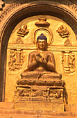 Gilded Buddha in teaching gesture. Placed on the wall of Mahabodhi Temple. Bodhgaya. Bihar. India.