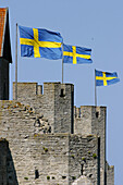 Swedish flags on the old town wall in Visby. Sweden 