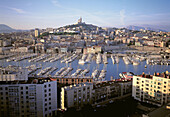Overhead view on Vieux Port, ND de la Garde basilica at rear, Marseille, France