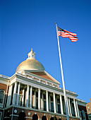 State Capitol and U.S. Flag. Boston. MA. USA