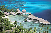 Overview on hotel bungalows on stilts over the lagoon. Bora Bora island, Leeward Islands. French Polynesia