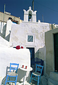 One table café terrace at Ia village. Santorini island. Cyclades. Greece