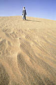 Tuareg on sand dunes. Hoggar area, Sahara desert. Algeria