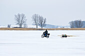 Icefisher on motorbike, Usedom, Mecklenburg Vorpommern, Germany