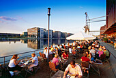People sitting in a pavement cafe, basin, Duisburg, North Rhine-Westphalia, Germany