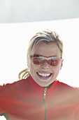 Woman wearing sunglasses smiling at camera, Styria, Austria