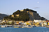 Spain, Alicante Province, Denia, marina, fort and waterfront with moon
