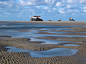 Beach, sand-mud flat, tide, tide-house/restaurant. St. Peter-Ording, Schleswig-Holstein Wadden Sea National Park, Germany