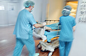 Carrying patient from operation room to resuscitation room, surgery area of hospital